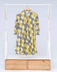 Display of yellow and black striped dress.