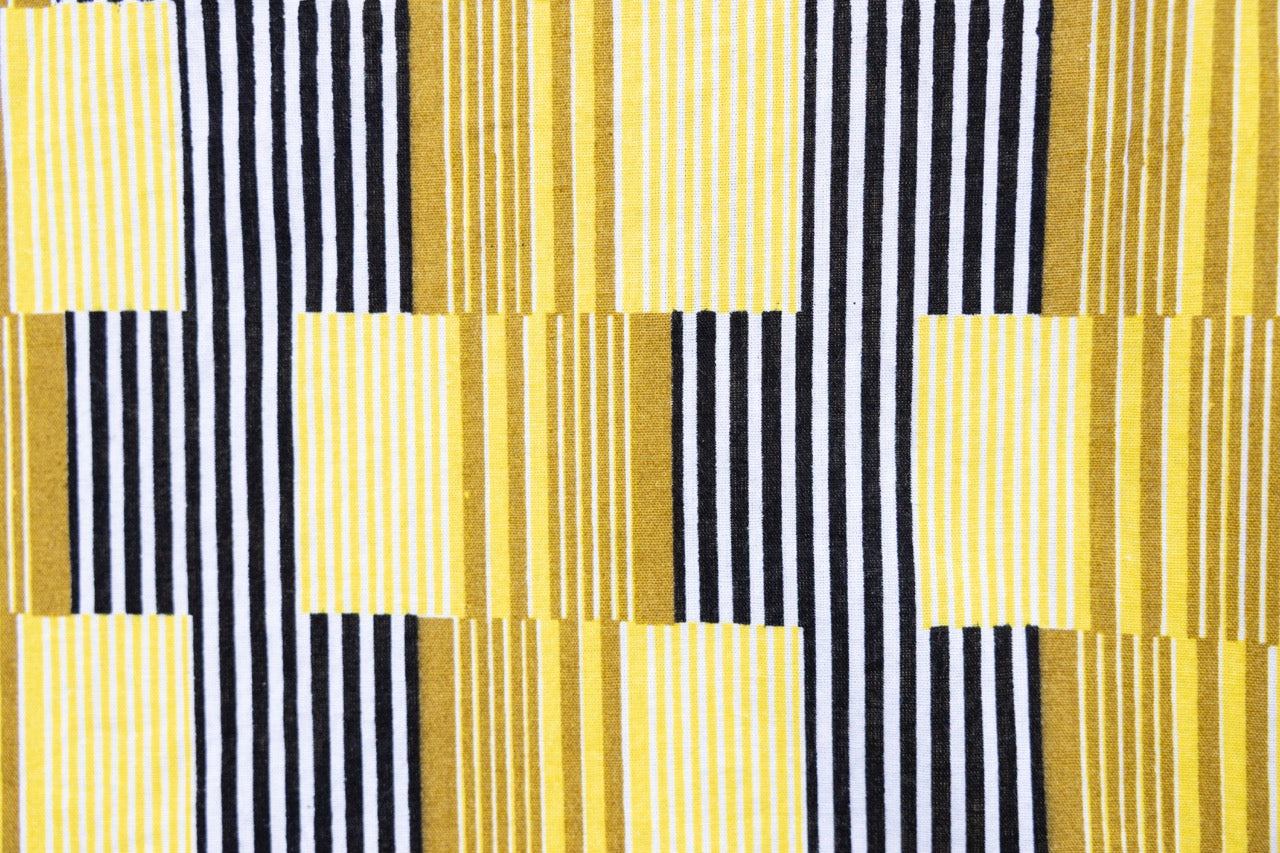 Close up display of yellow and black striped dress, fabric.