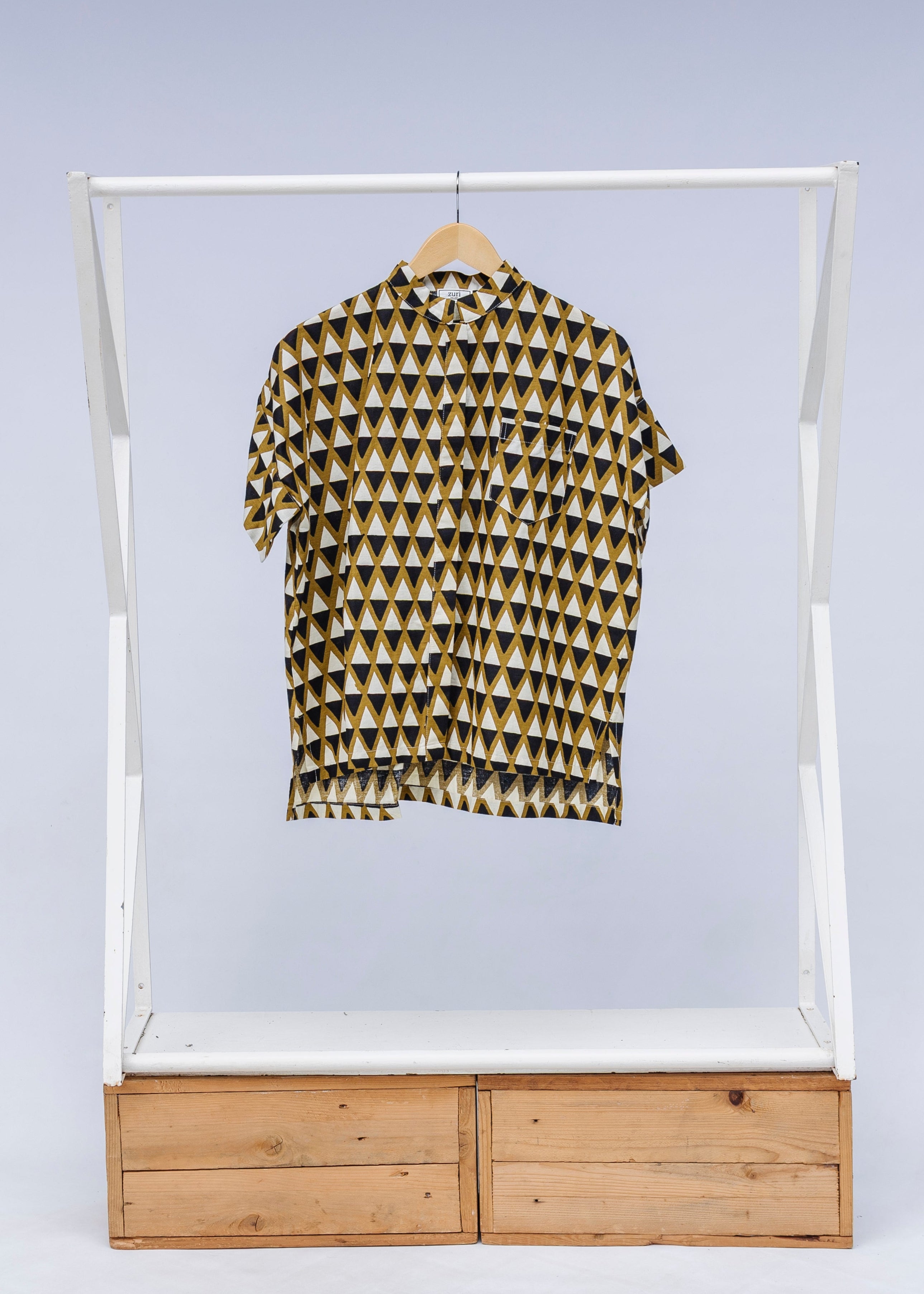 Display of black and white triangle print shirt.