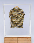 Display of black and white triangle print shirt.