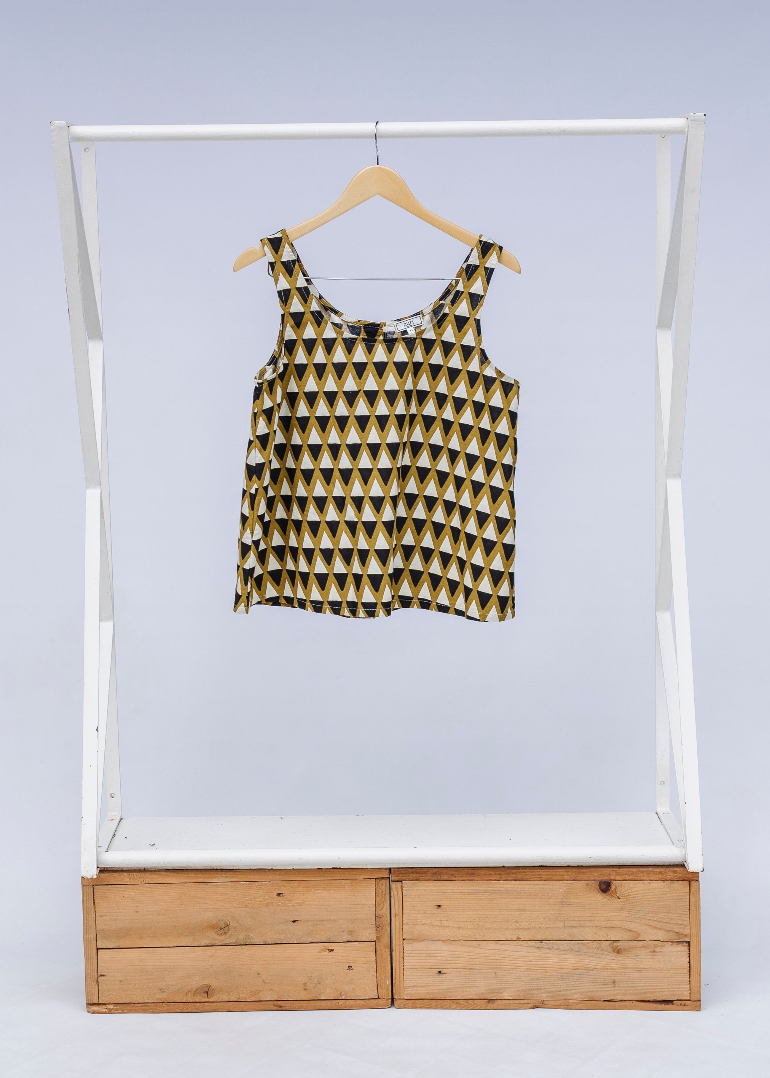 Display of mustard and black triangle print tank.