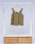 Display of mustard and black triangle print tank.