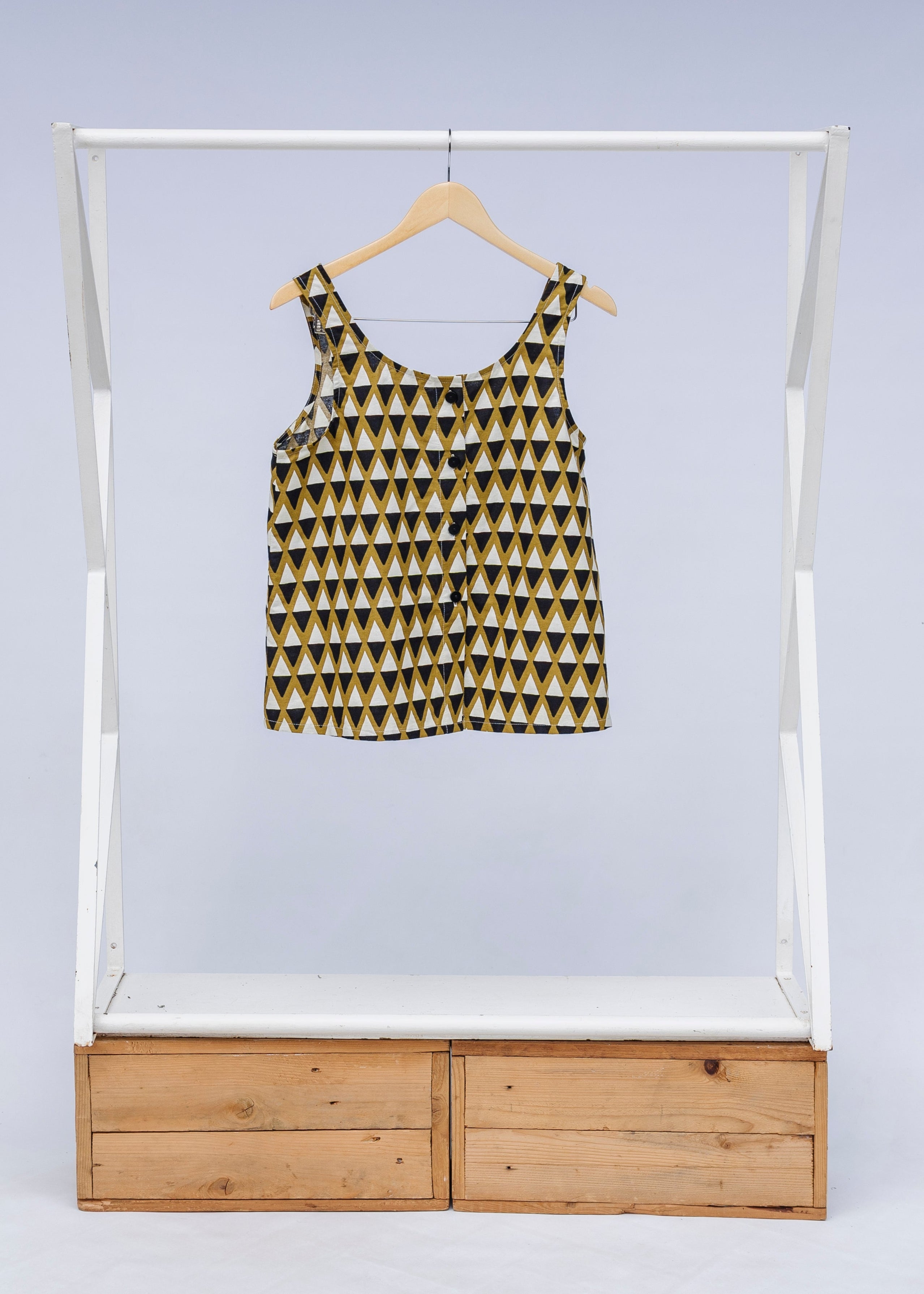 Display of mustard and black triangle print tank.