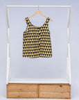 Display of mustard and black triangle print tank.