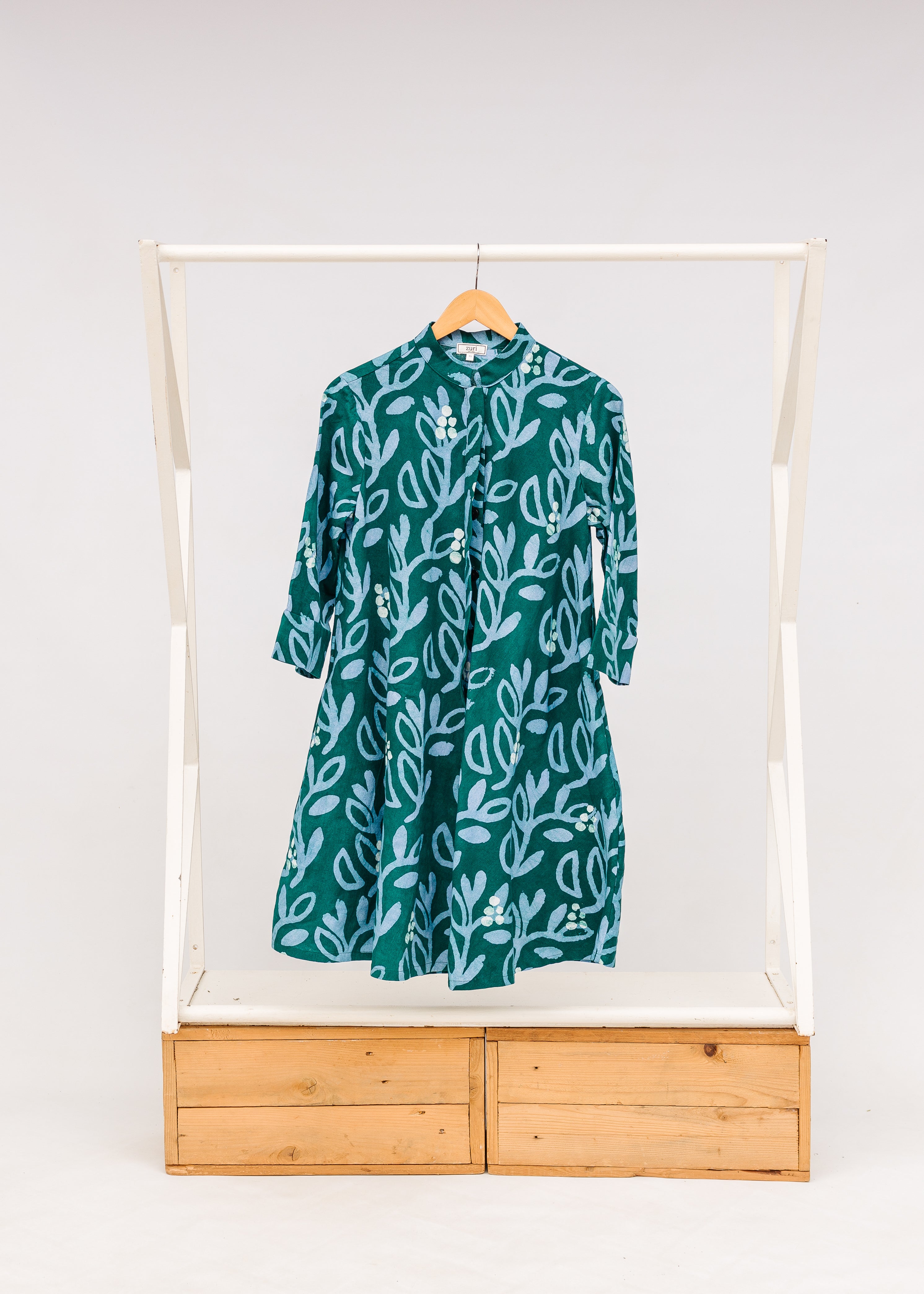 Display of green and blue floral batik dress. 