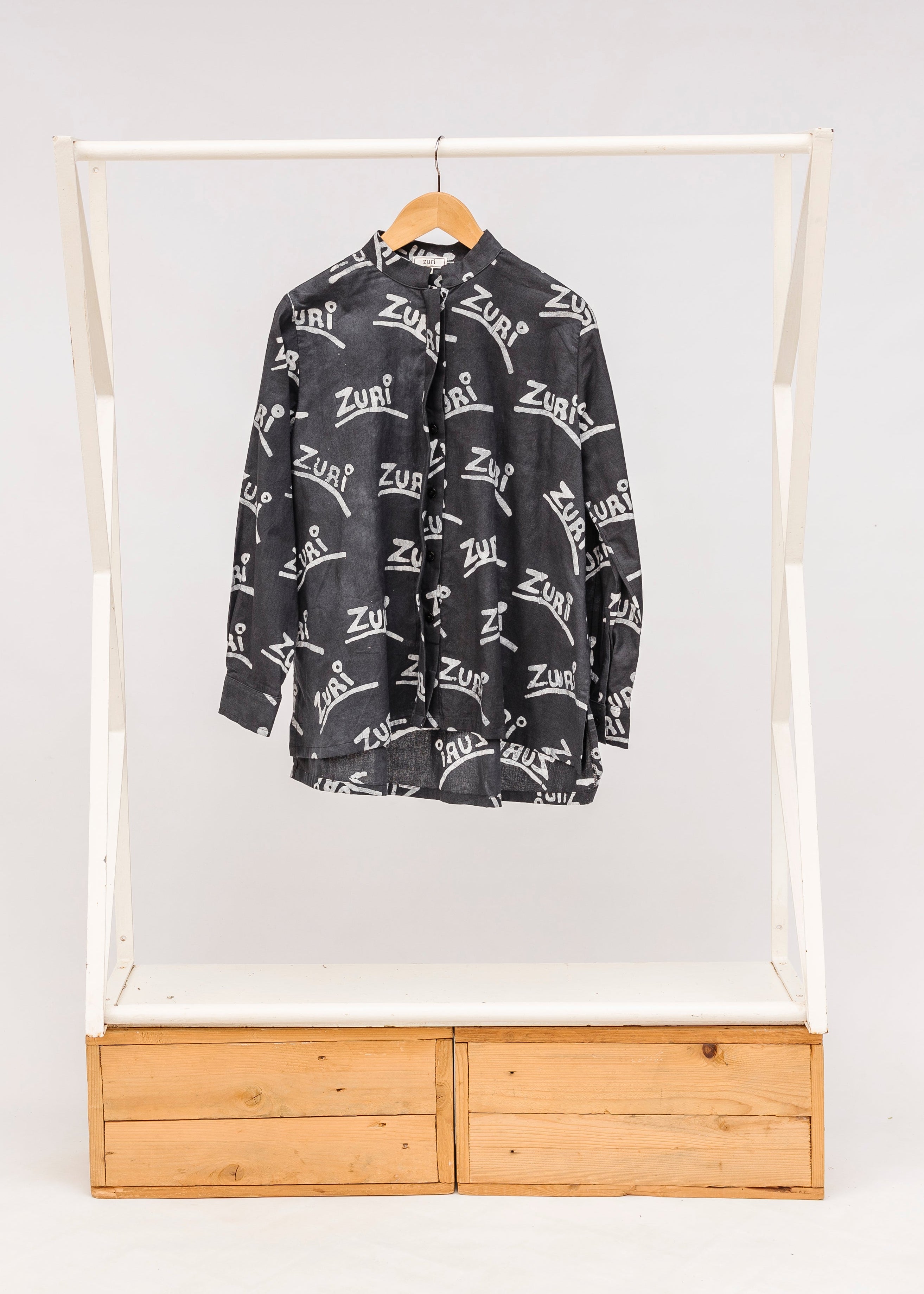 Display of black and white long sleeve shirt with Zuri graphic print.