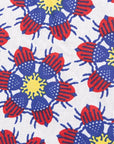 Close up display of dress with yellow, red and blue bug print.