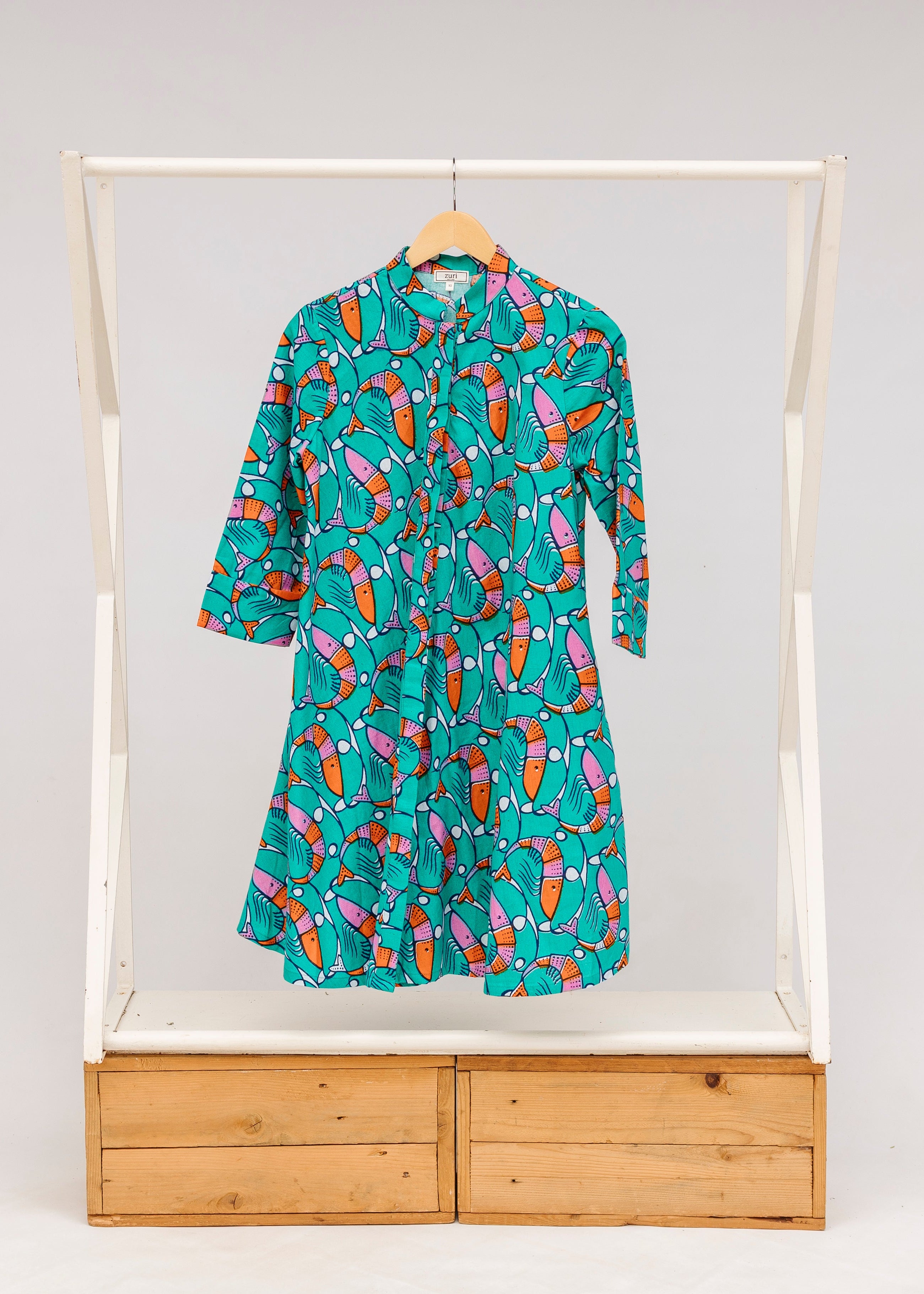 Display of teal dress with pink and orange shrimp print.