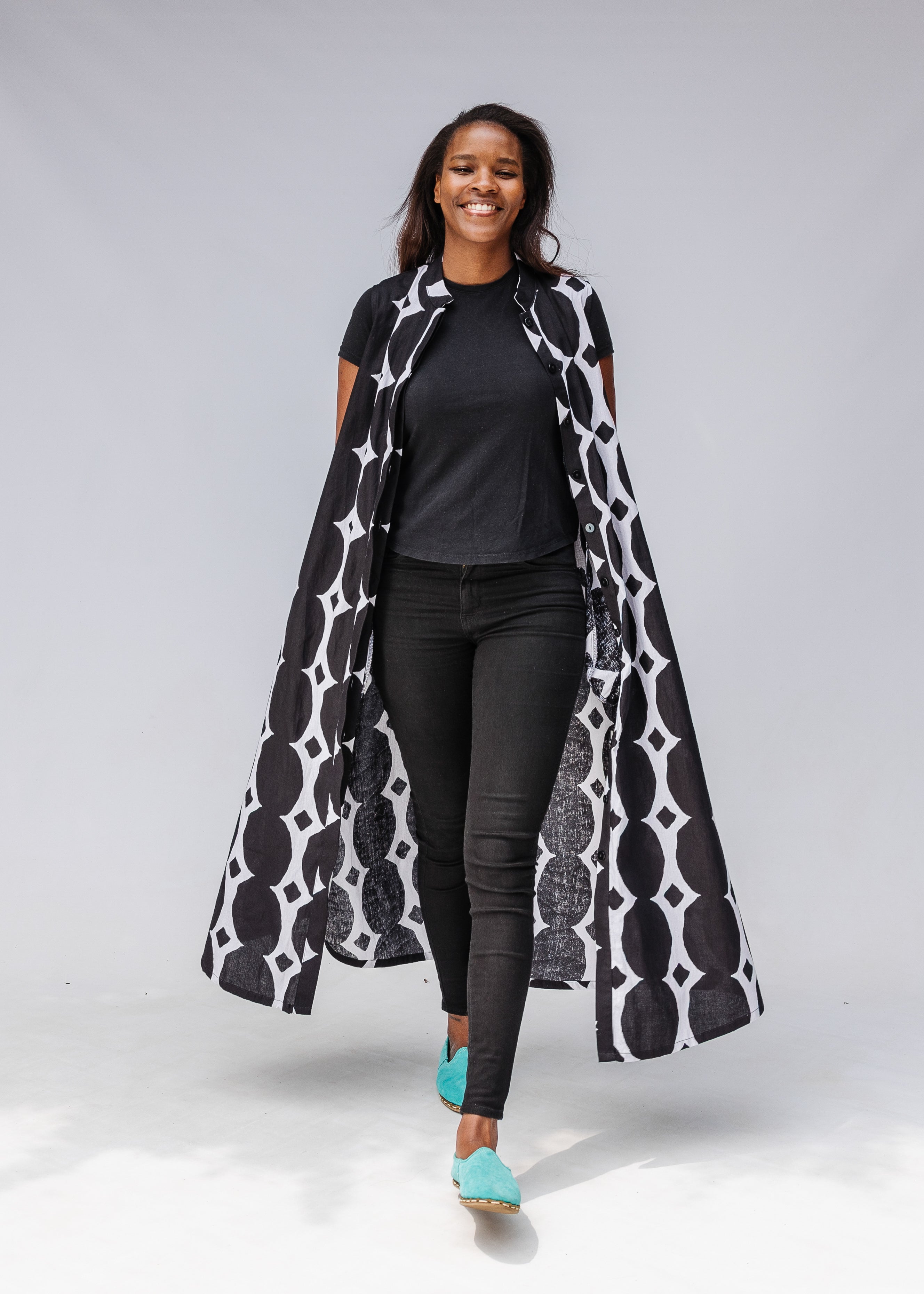 Model wearing black and white geometric print dress.