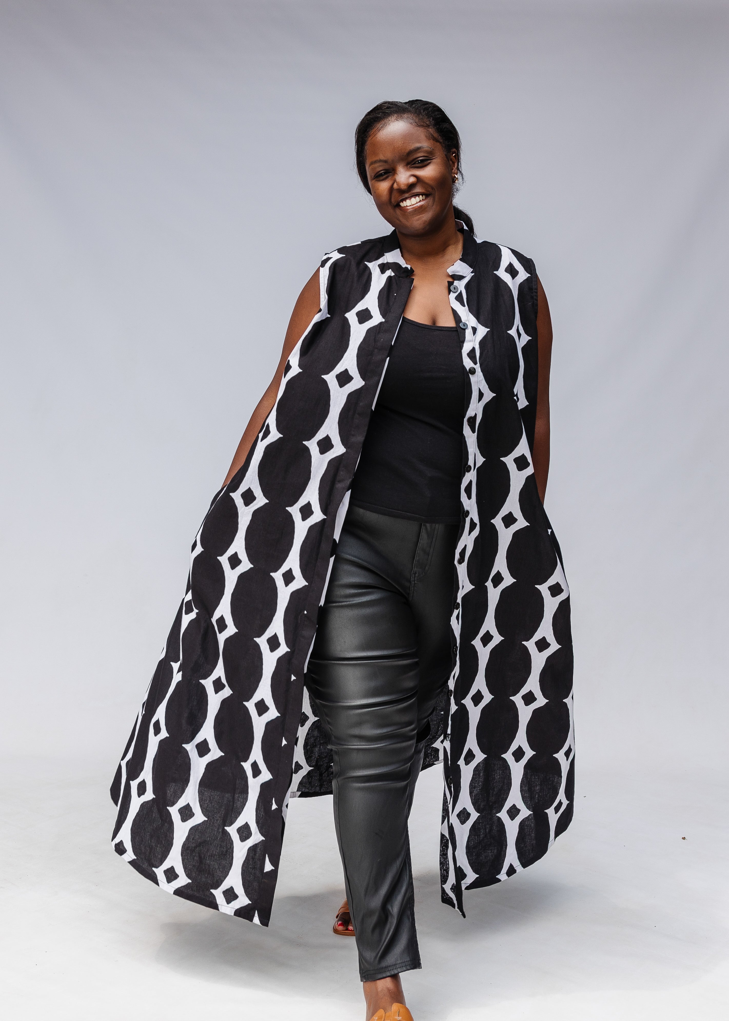 Model wearing black and white geometric print dress.
