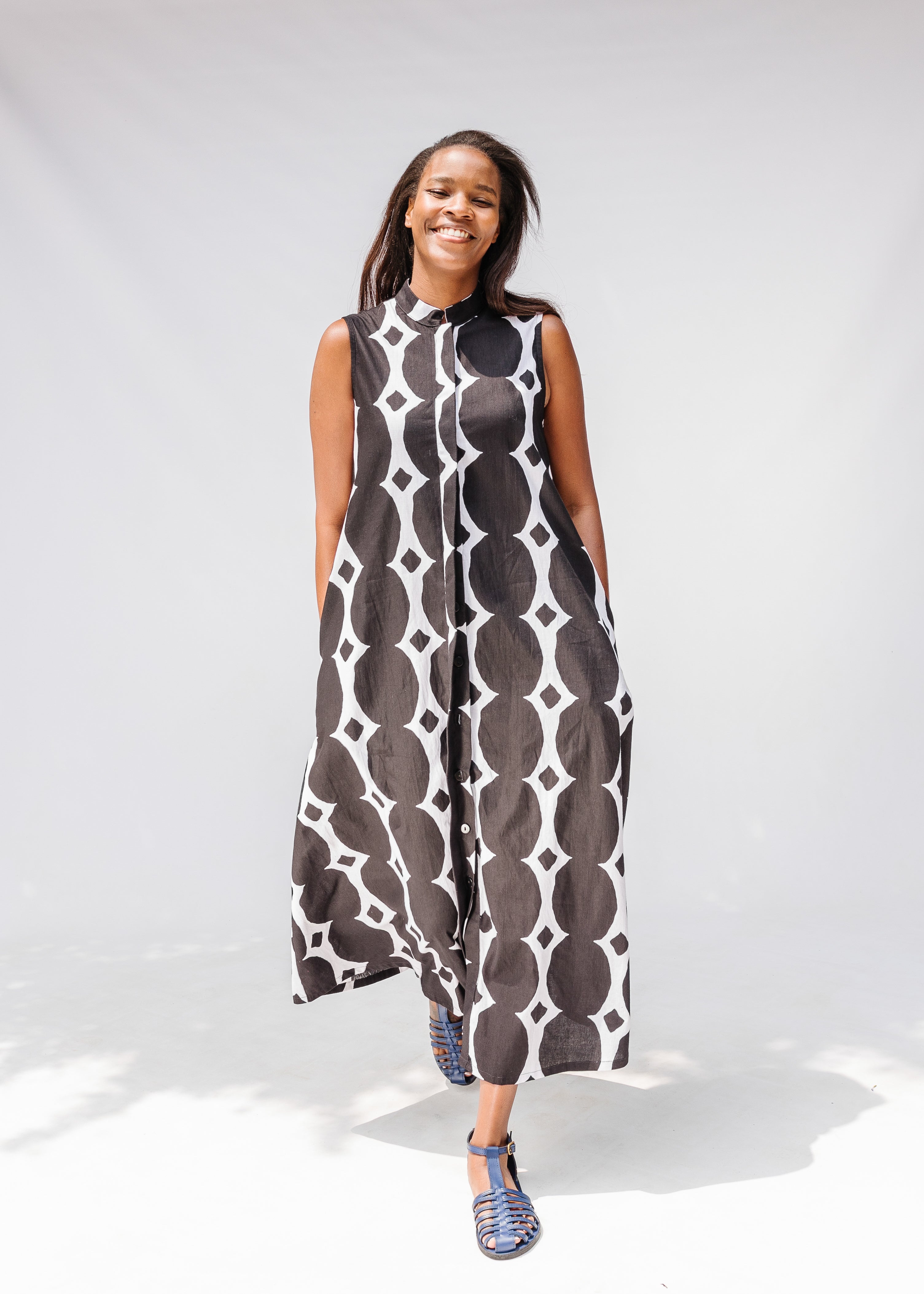 Model wearing black and white geometric print dress.
