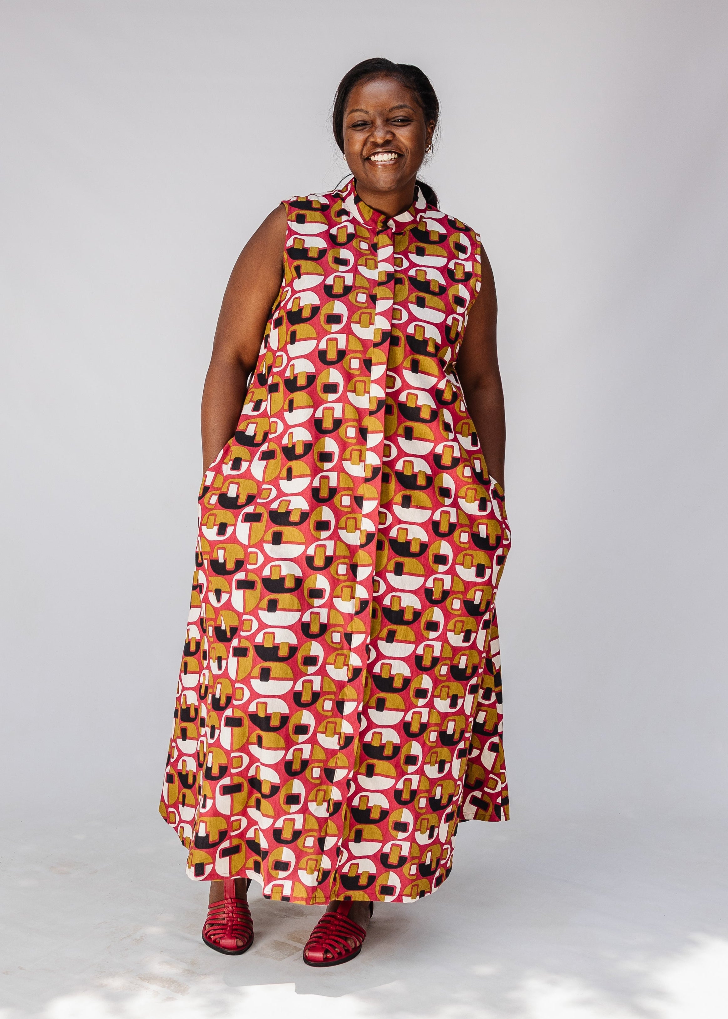 Model wearing geometric print dress.