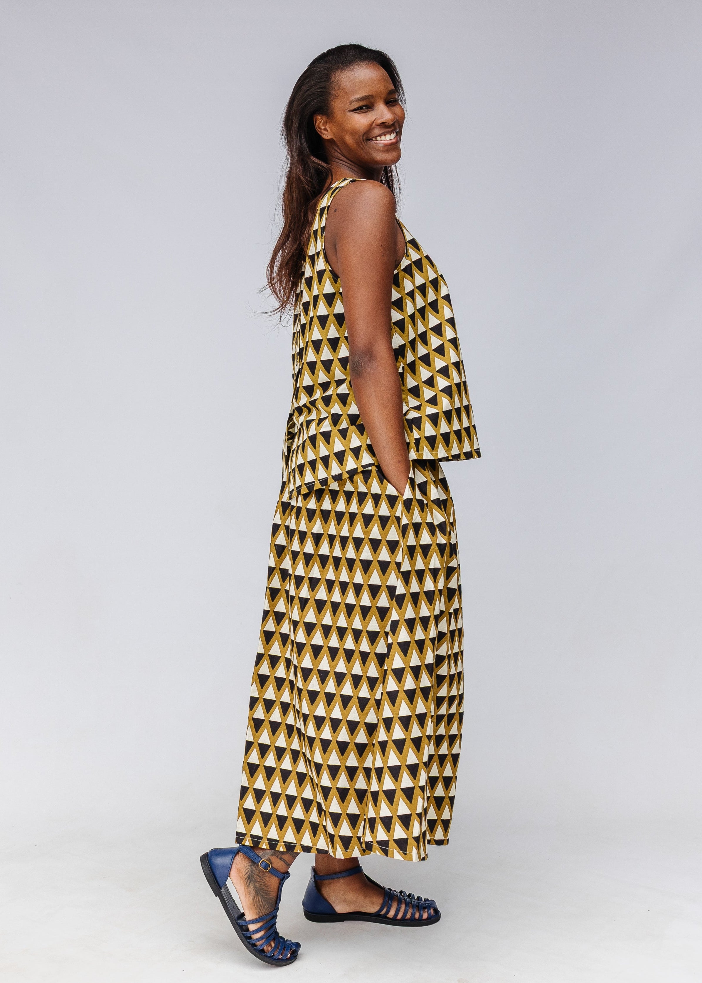 Model wearing black and white triangle print shirt and pants.