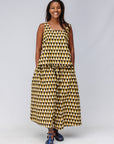 Model wearing mustard and black triangle print pants and tank.
