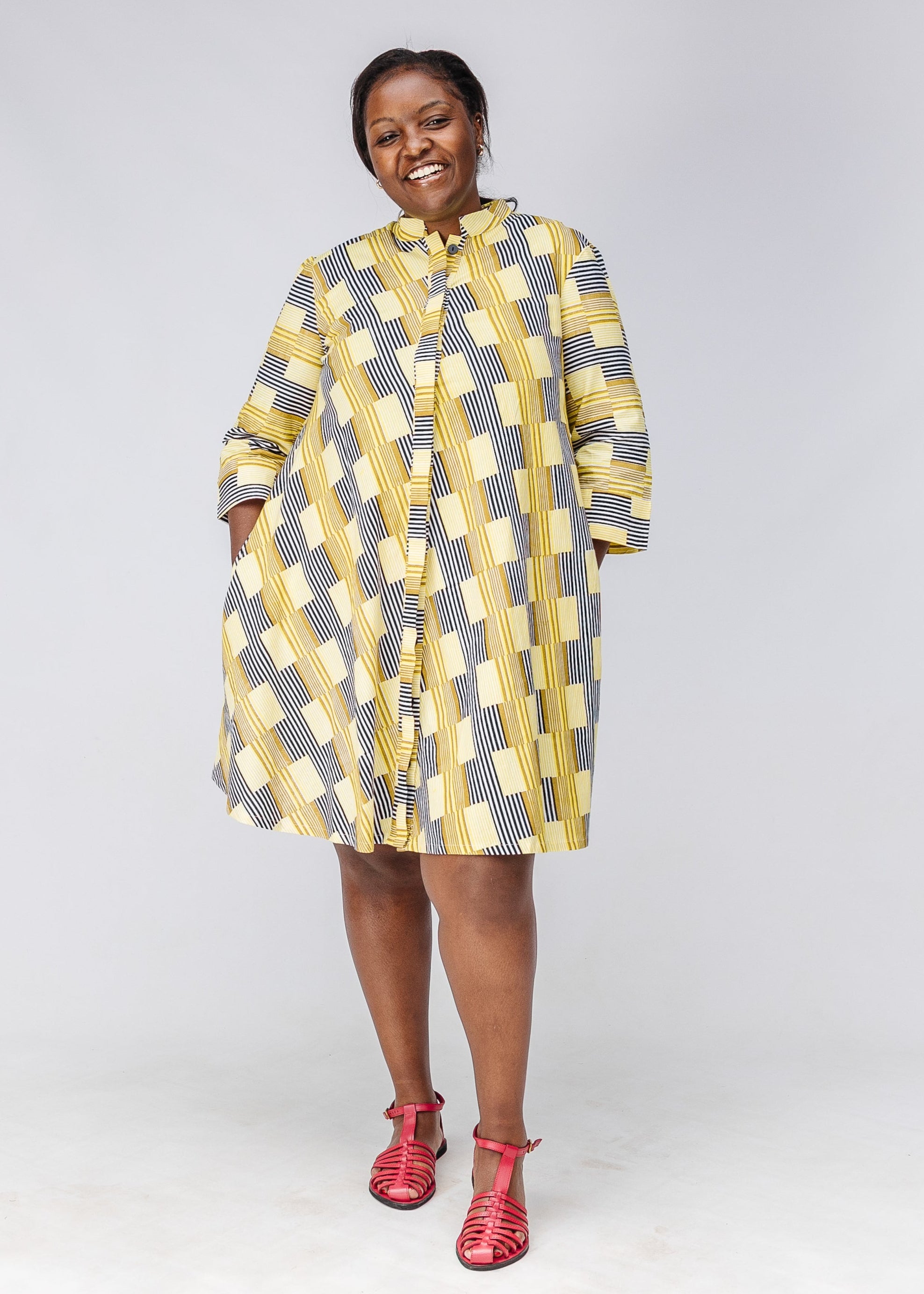 Model wearing yellow and black striped dress.