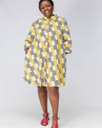 Model wearing yellow and black striped dress.