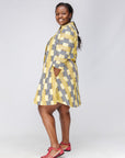 Model wearing yellow and black striped dress.