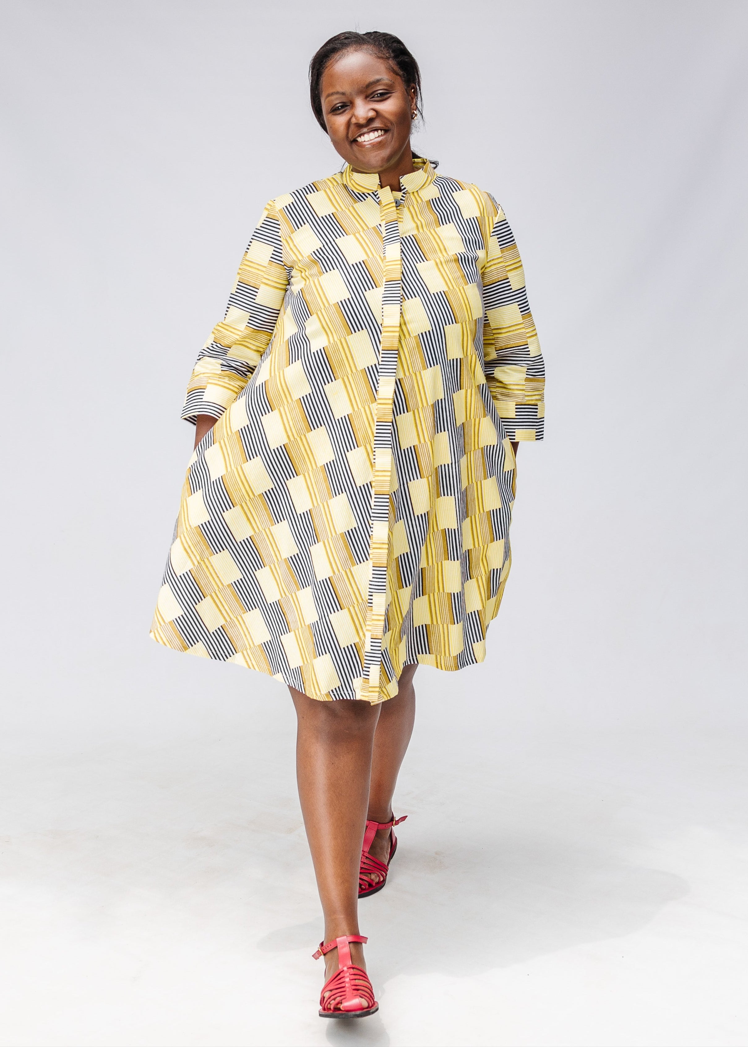 Model wearing yellow and black striped dress.