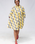 Model wearing yellow and black striped dress.