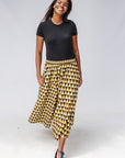 Model wearing mustard and black triangle print pants.