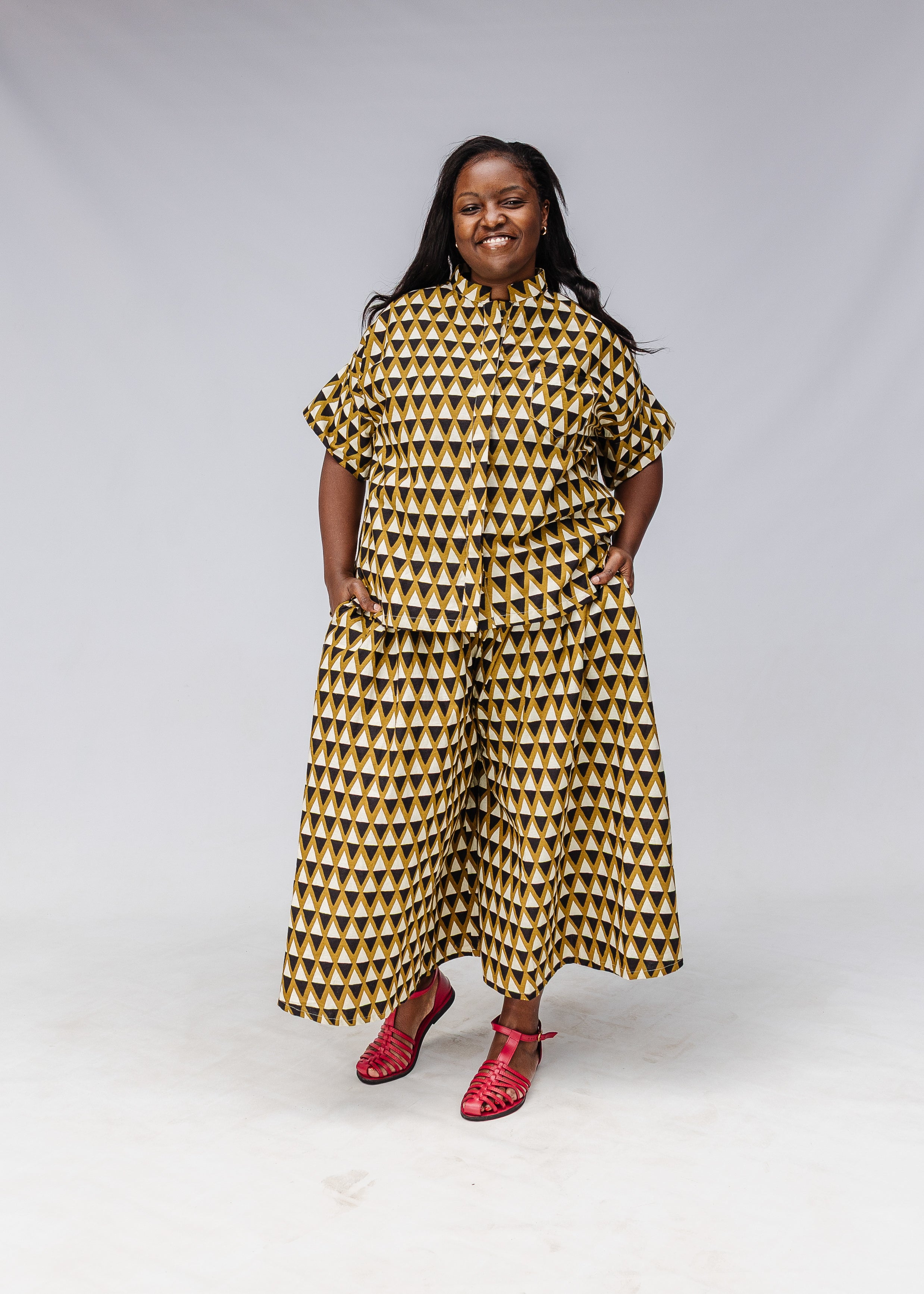 Model wearing black and white triangle print shirt and pants.