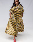 Model wearing mustard and black triangle print pants and shirt.