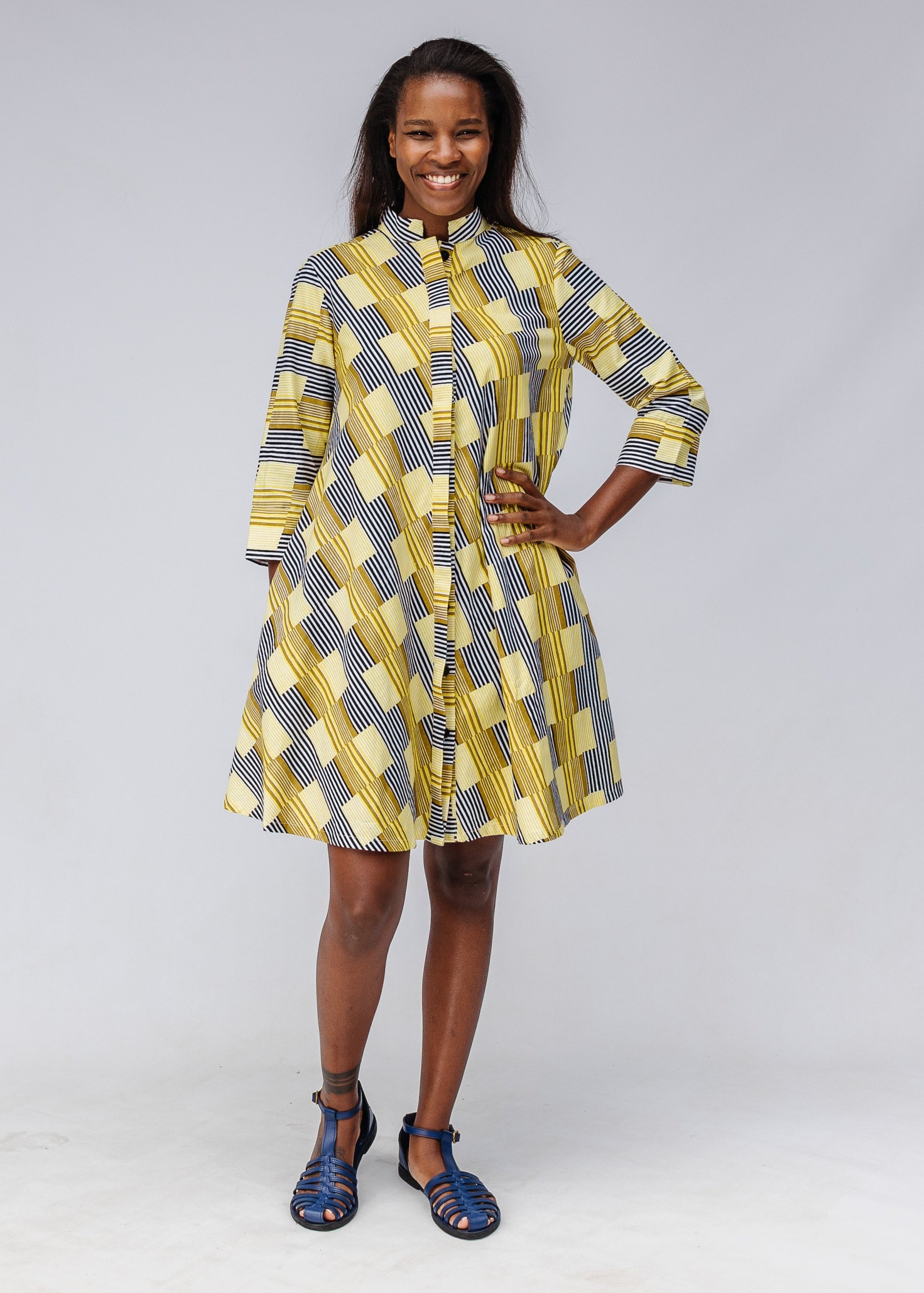 Model wearing yellow and black striped dress.