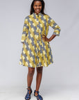 Model wearing yellow and black striped dress.