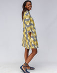 Model wearing yellow and black striped dress.
