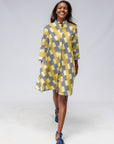 Model wearing yellow and black striped dress.