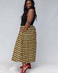 Model wearing mustard and black triangle print pants.