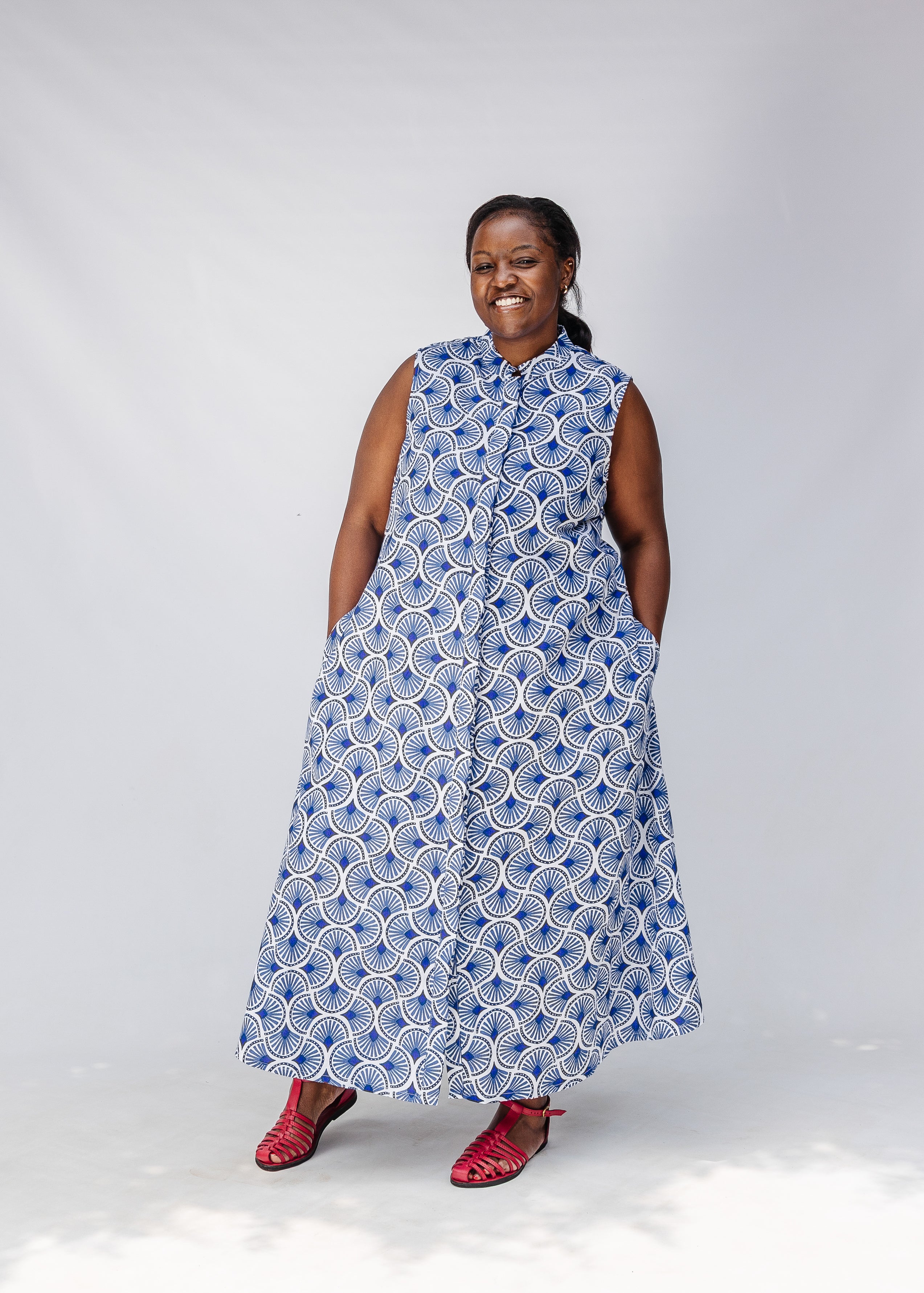 Model wearing blue and white mosaic print dress.
