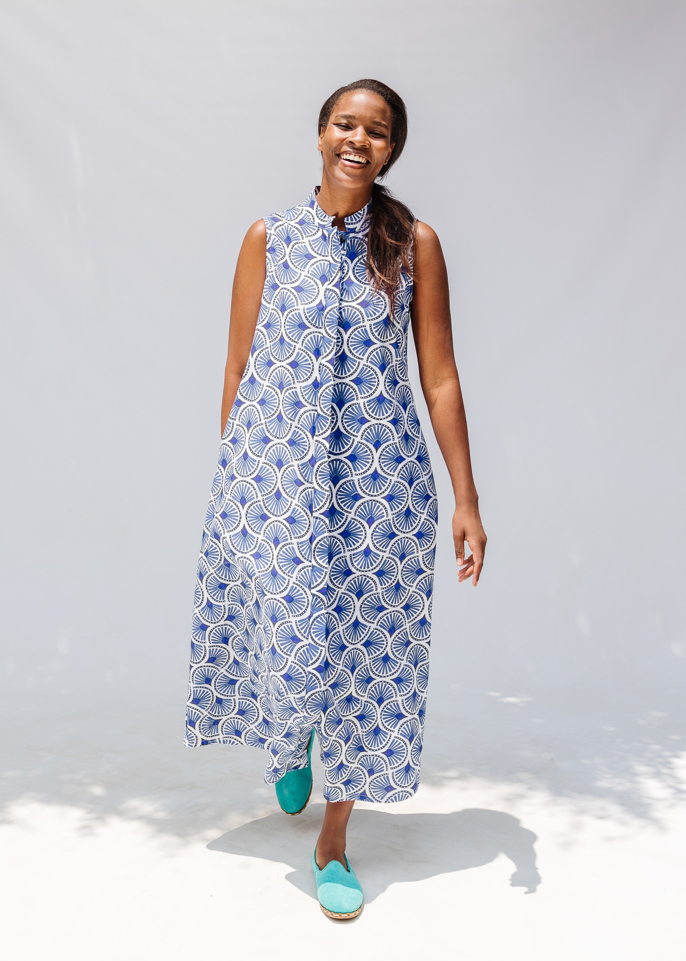 Model wearing blue and white mosaic print dress.