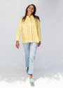 Model wearing yellow long sleeve shirt with white leaf print.