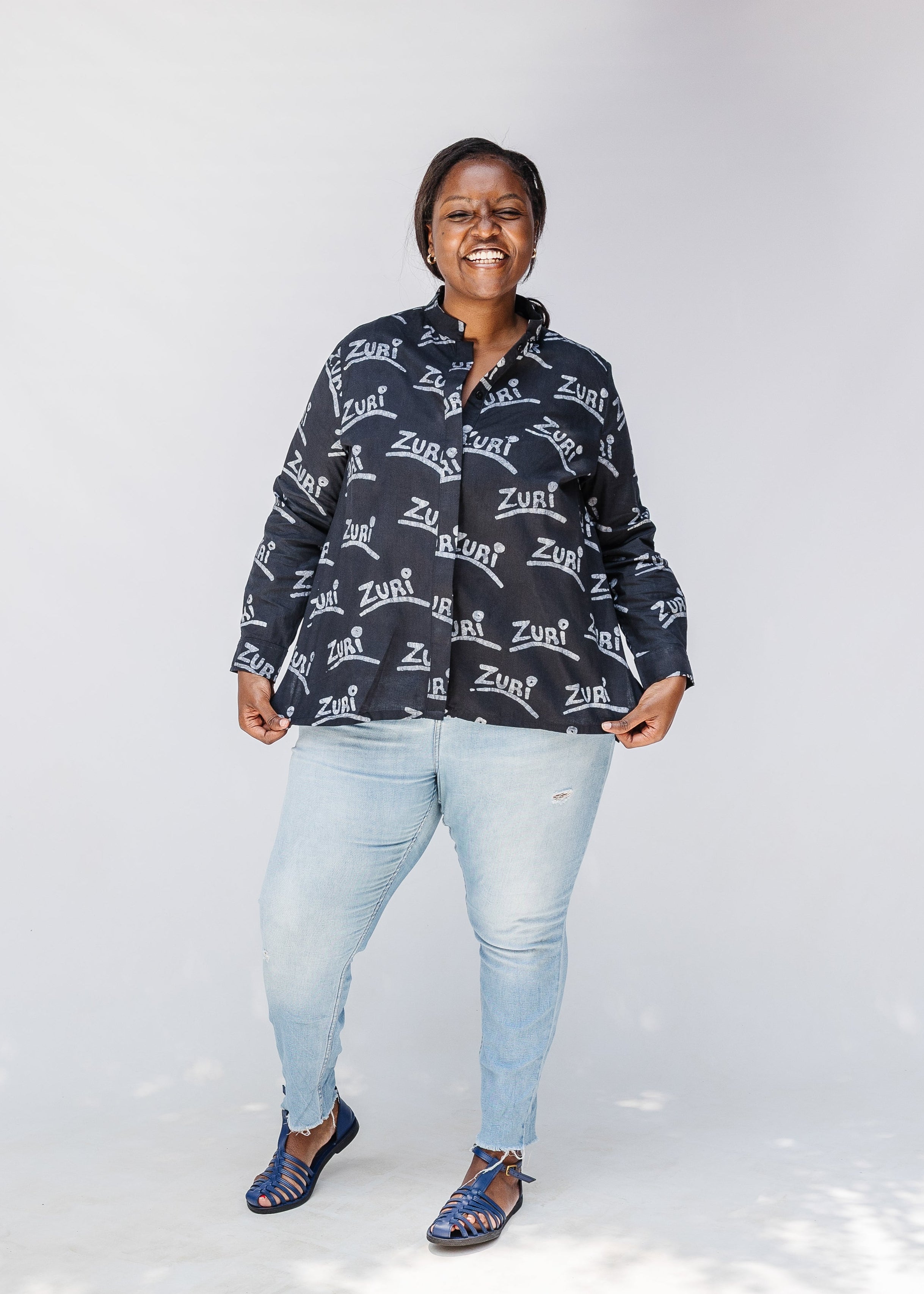 Model wearing black and white long sleeve shirt with Zuri graphic print.