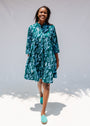 Model wearing green and blue floral batik dress. 