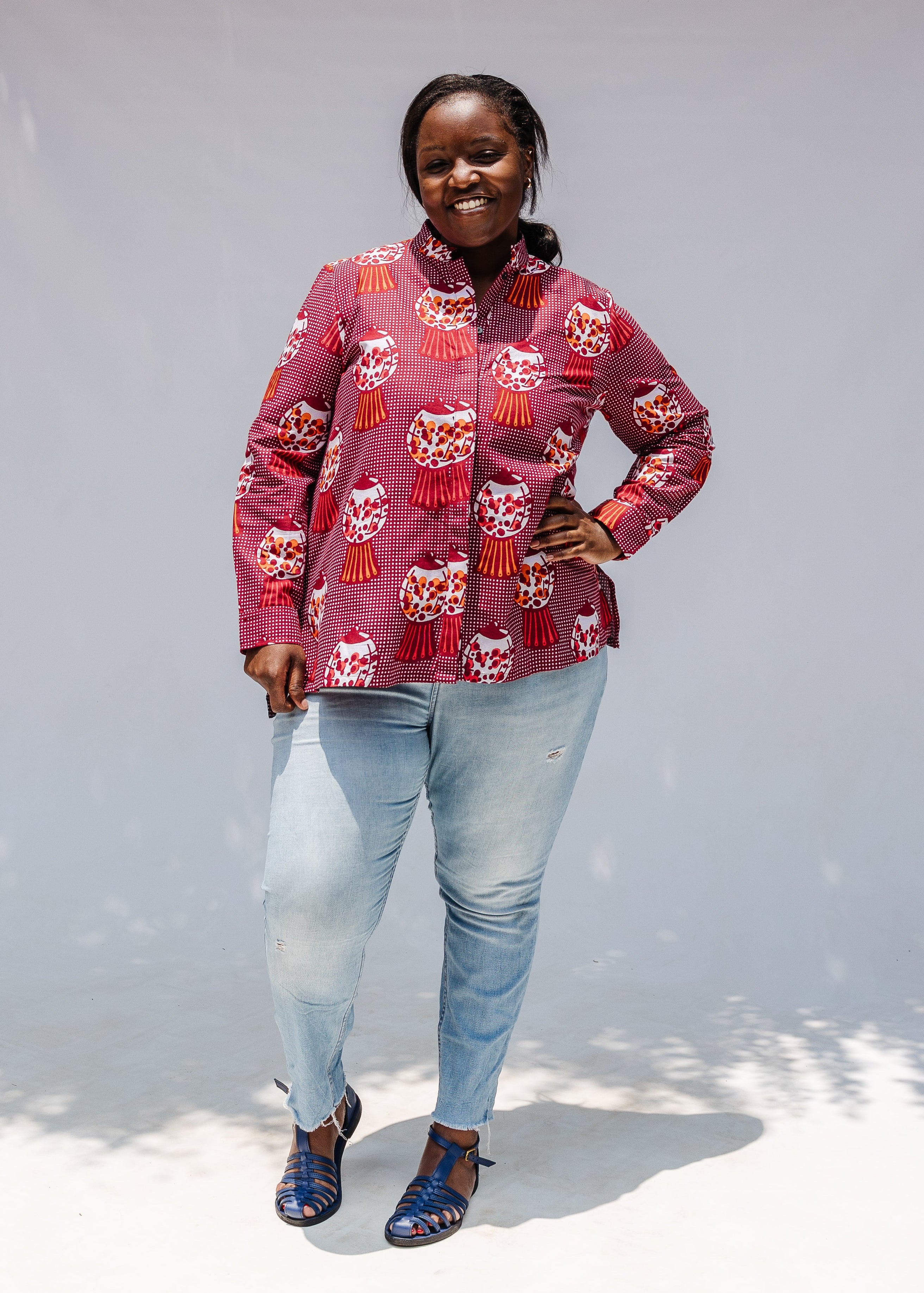 Model wearing red shirt with orange and white gumball print.