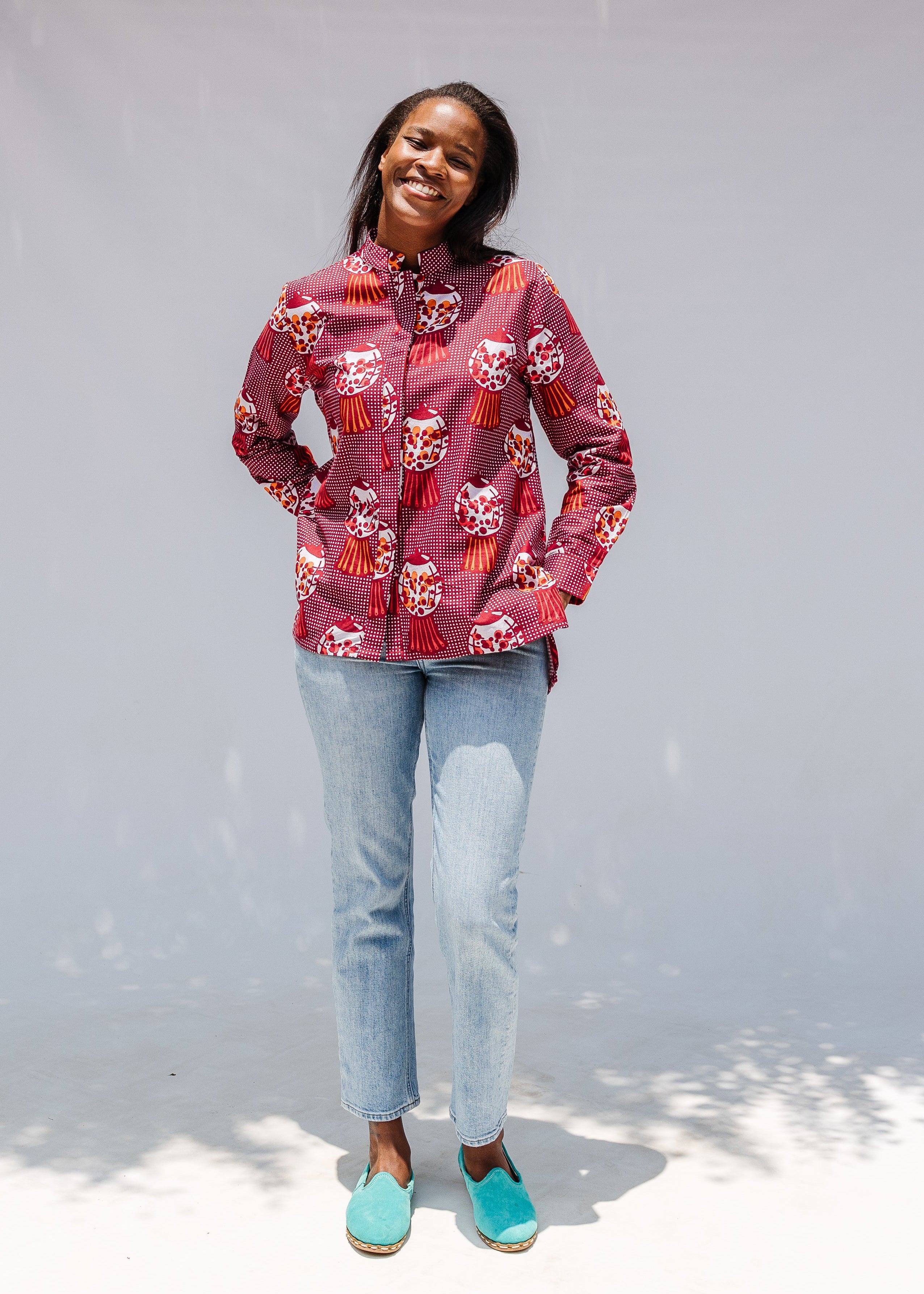 Model wearing red shirt with orange and white gumball print.