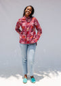 Model wearing red shirt with orange and white gumball print.