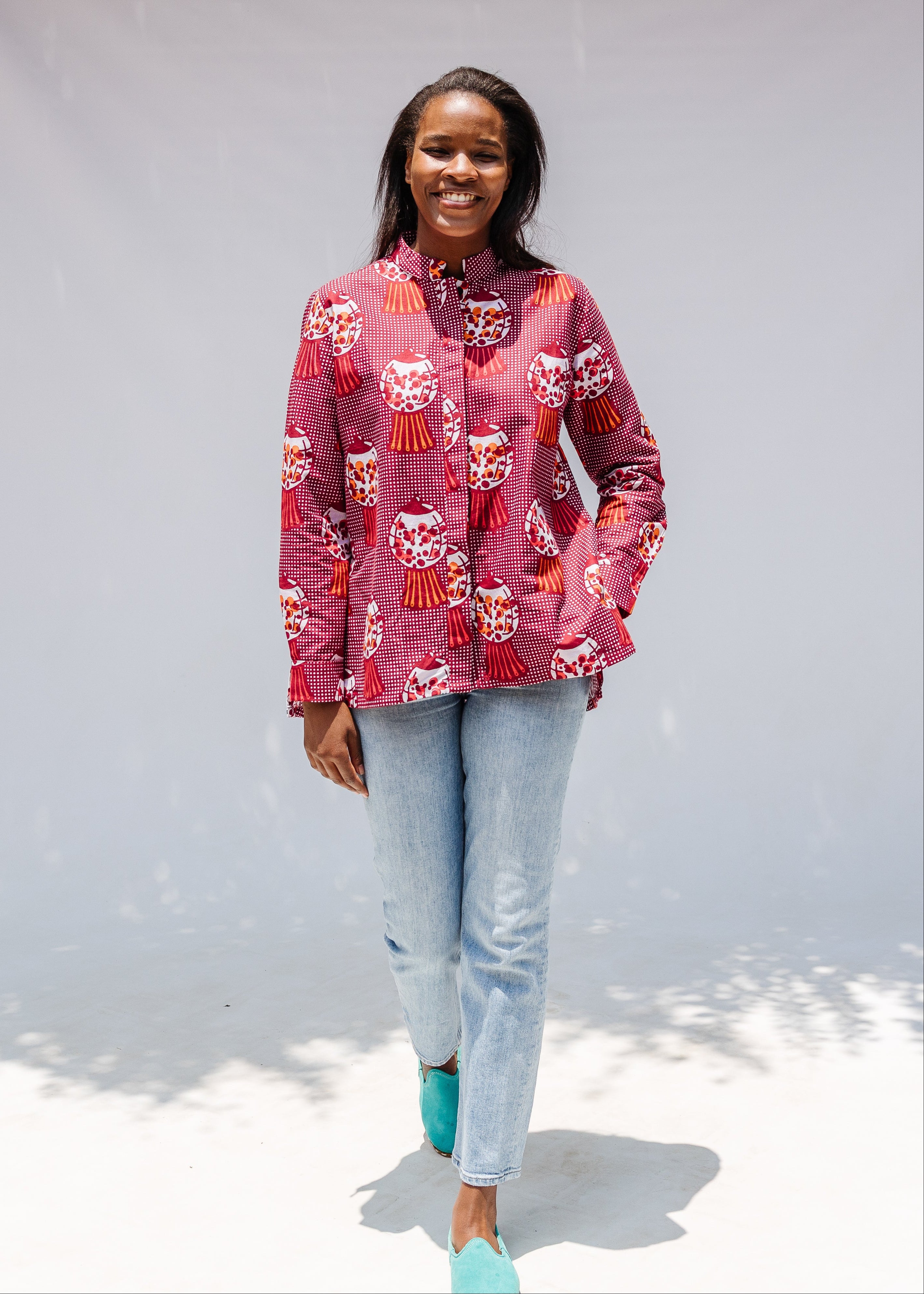 Model wearing red shirt with orange and white gumball print.