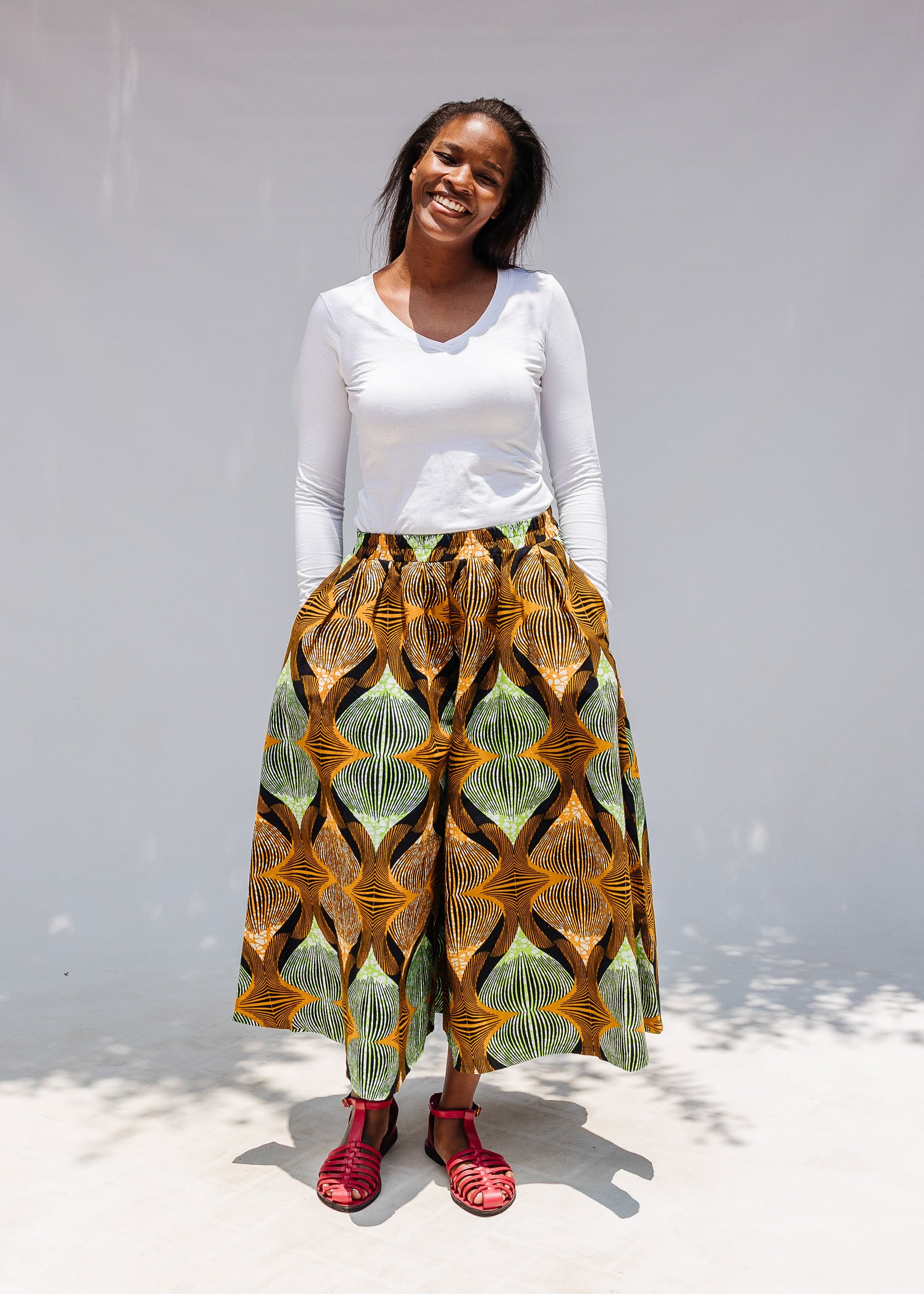 Model wearing orange and green geometric print pants.