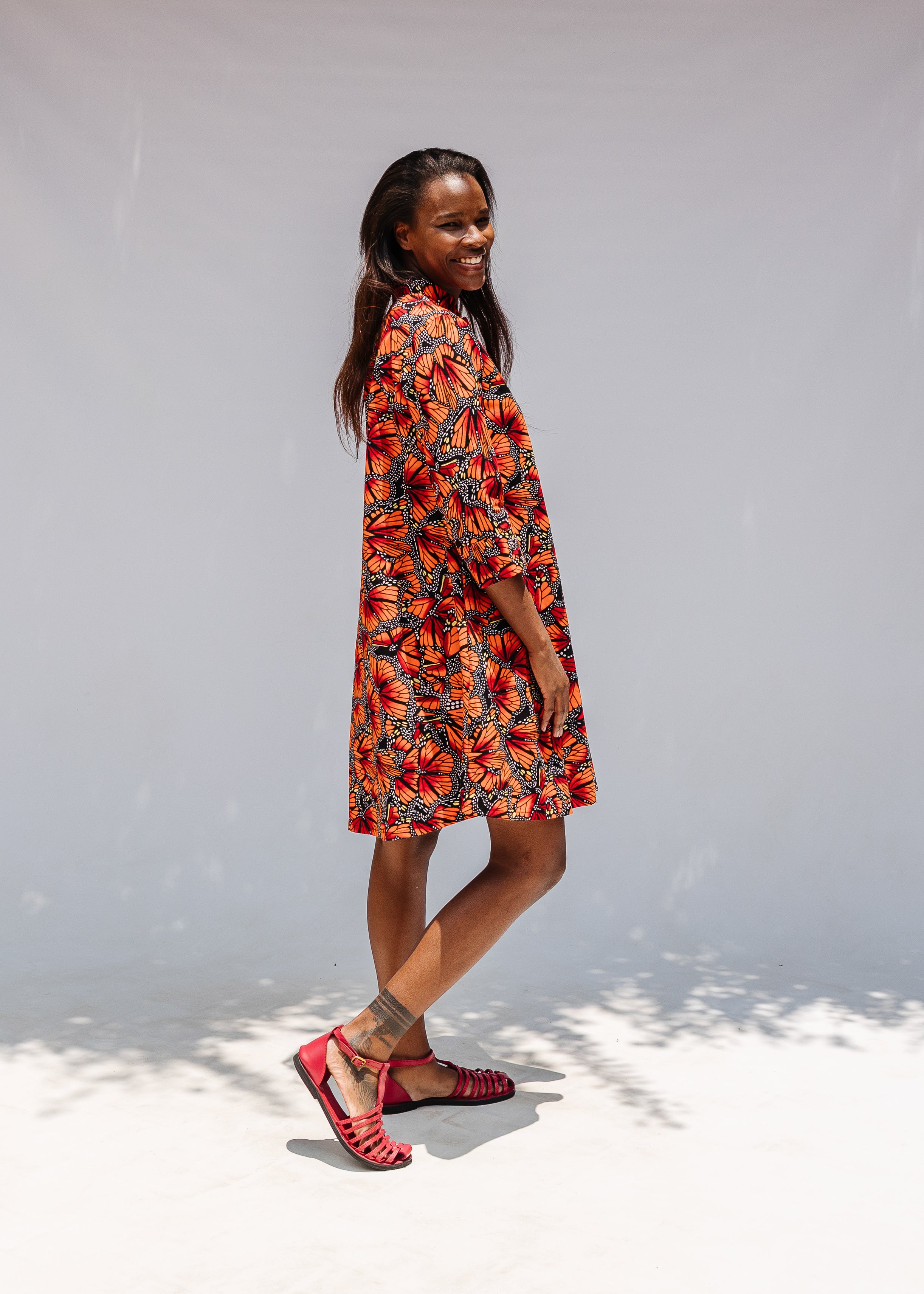 Model wearing butterfly print dress.