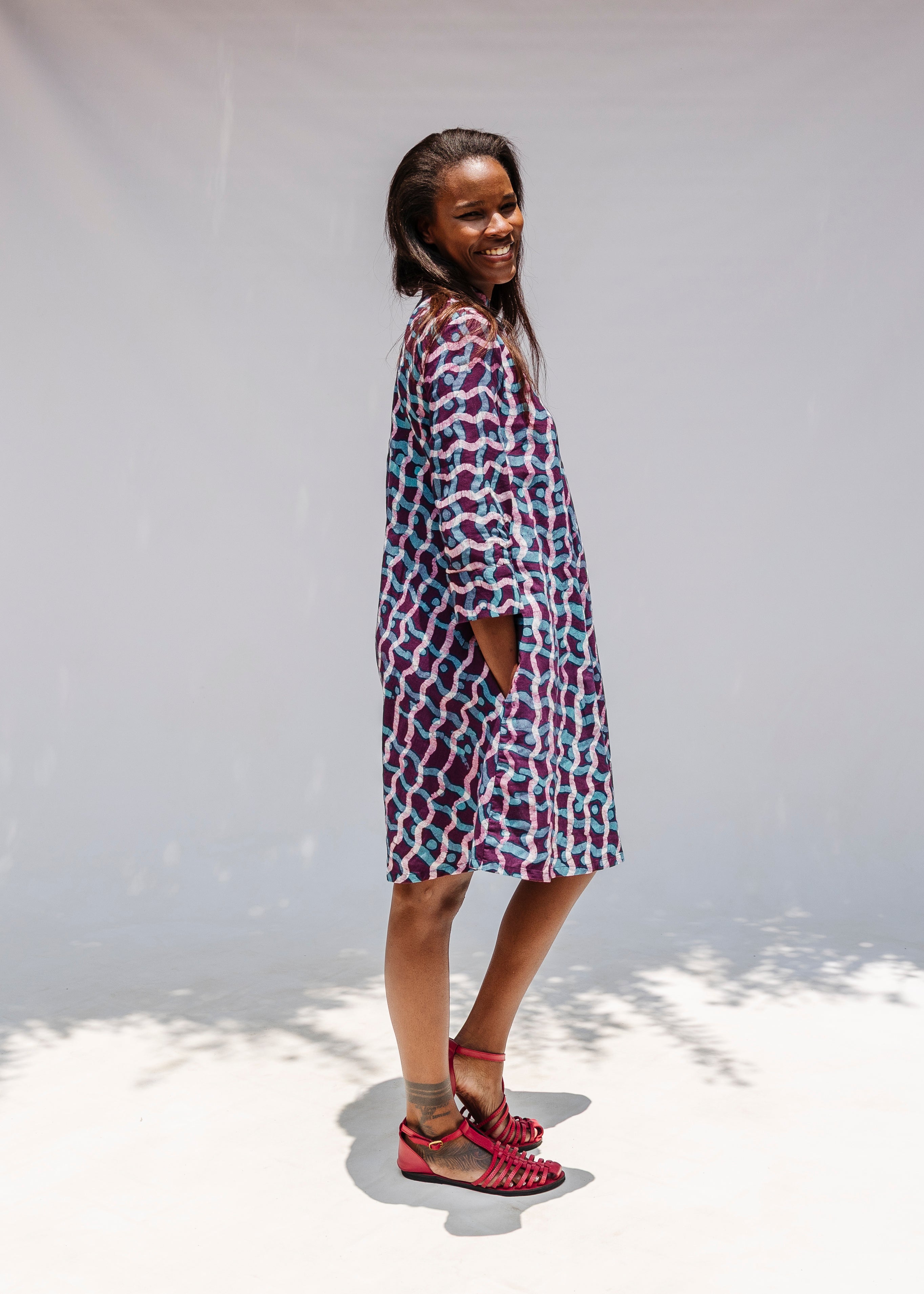 Model wearing purple and blue batik dress.