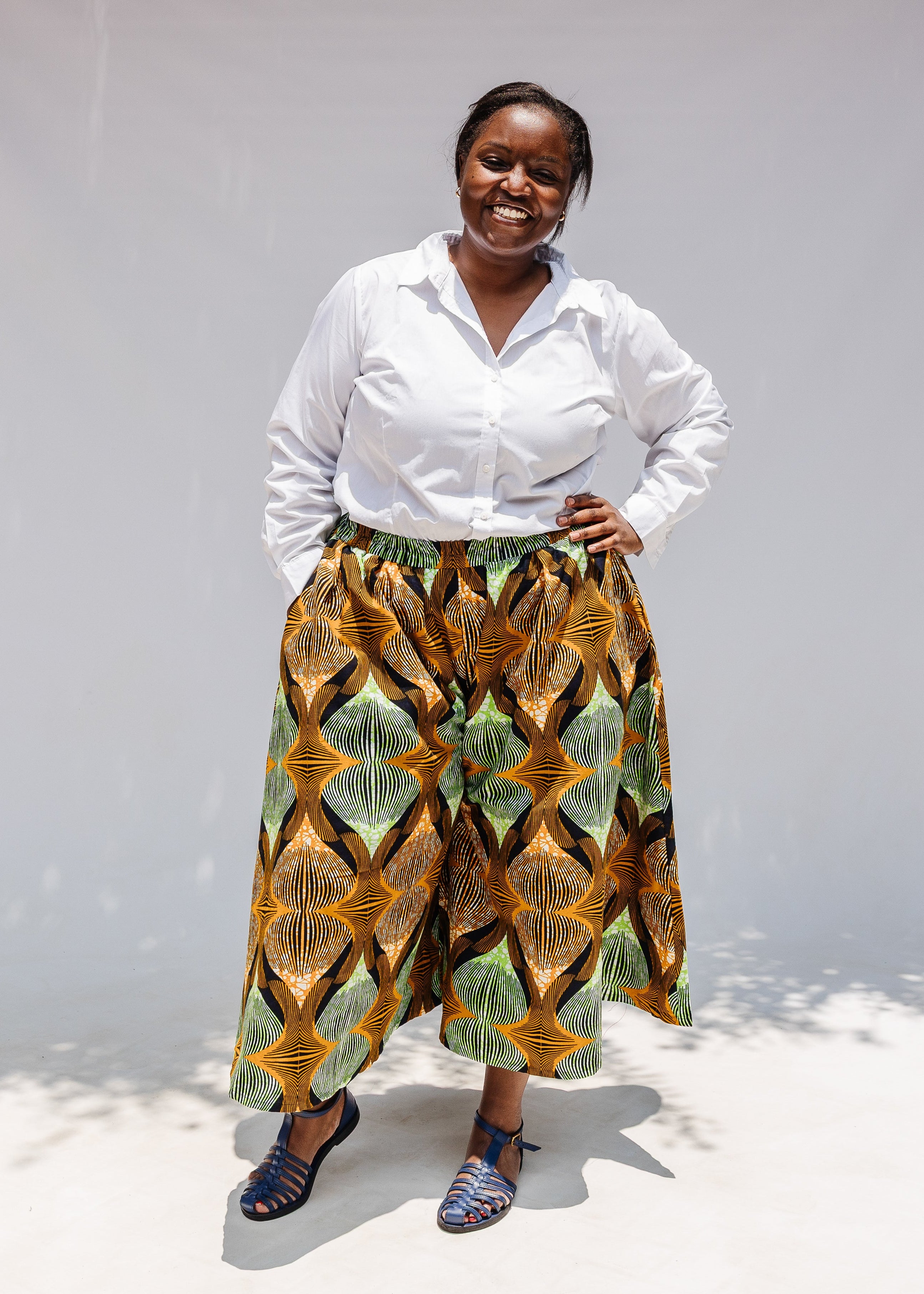 Model wearing orange and green geometric print pants.