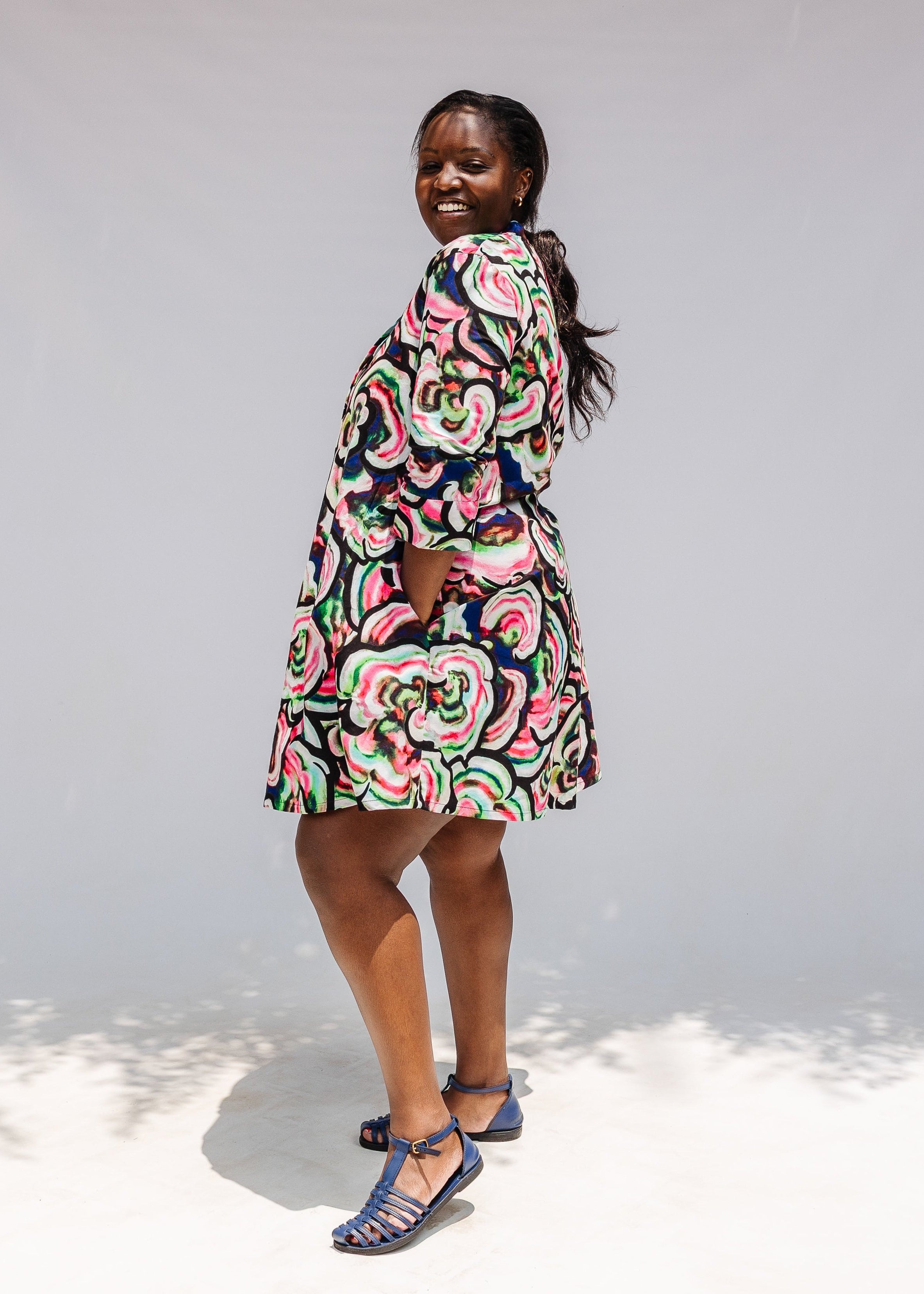 Model wearing colorful abstract print dress.