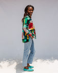 Model wearing mutlicolor abstract print shirt.