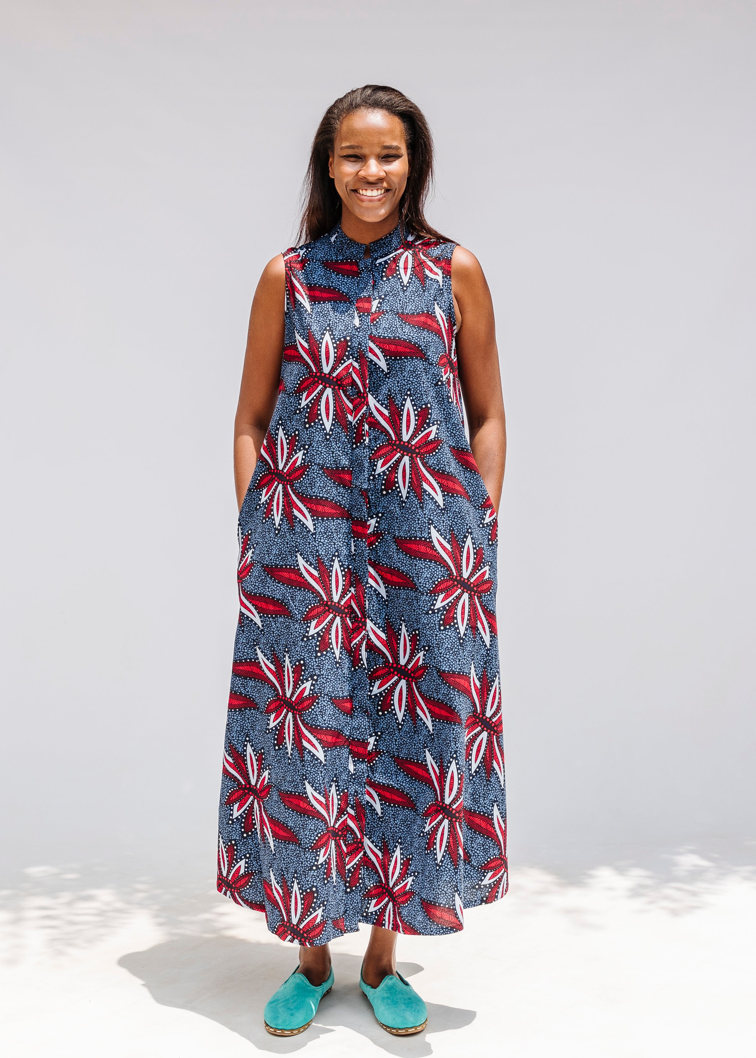 Model wearing grey, red and black dragonfly print dress.