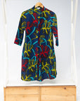 Display of blue, red, yellow, black and aqua vine print dress