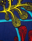 Close up display of blue, red, yellow, black and aqua vine print dress