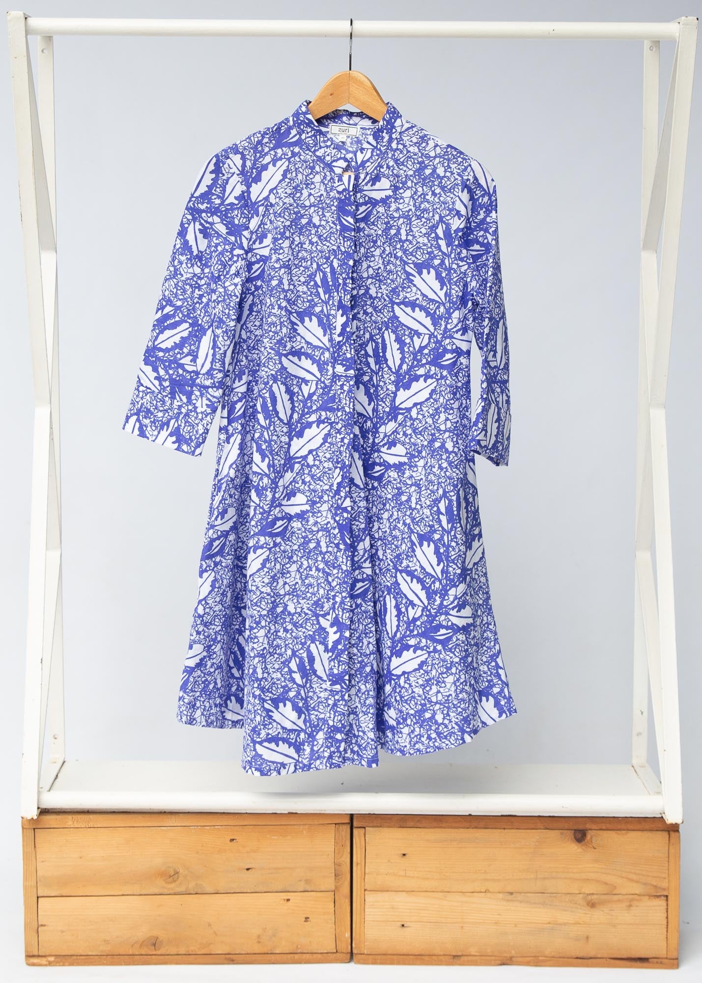Display of violet and white leaf print dress